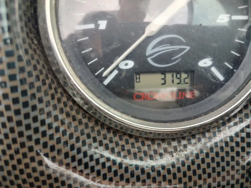 Slide: The Image of Close-up of a Crownline 270 BR 2005 boat gauge displaying 319.2 hours. - 31