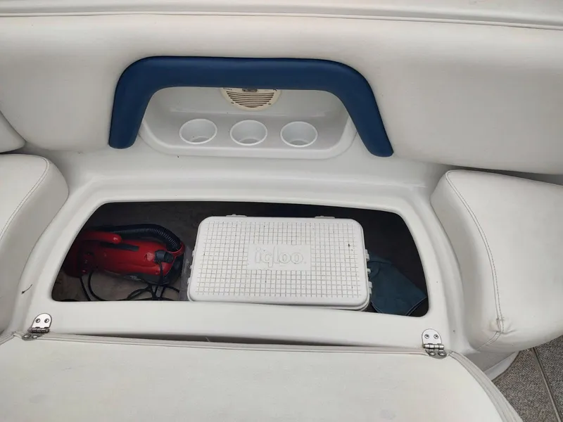 Slide: The Image of Storage compartment in a 2005 Crownline 270 BR boat with cooler and vacuum. - 32