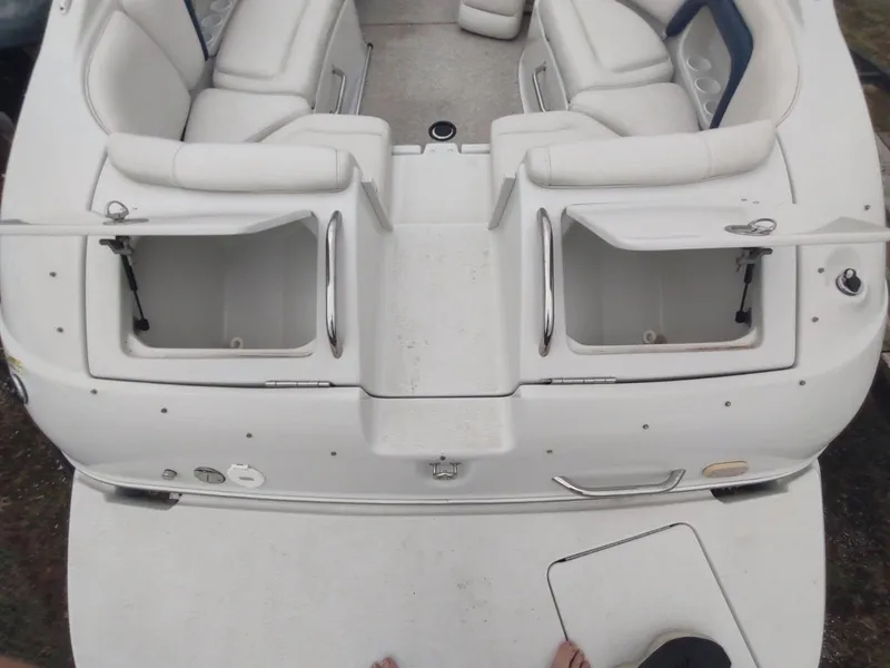 Slide: The Image of 2005 Crownline 270 BR boat interior with white seating and open storage compartments. - 5