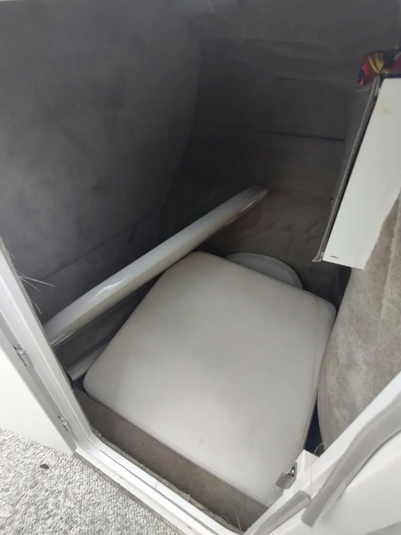 Slide: The Image of 2005 Crownline 270 BR boat interior storage compartment with cushion and panel. - 6