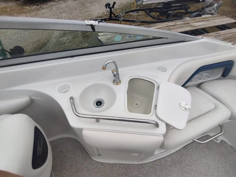 Slide: The Image of 2005 Crownline 270 BR boat interior with sink and storage compartment. - 8