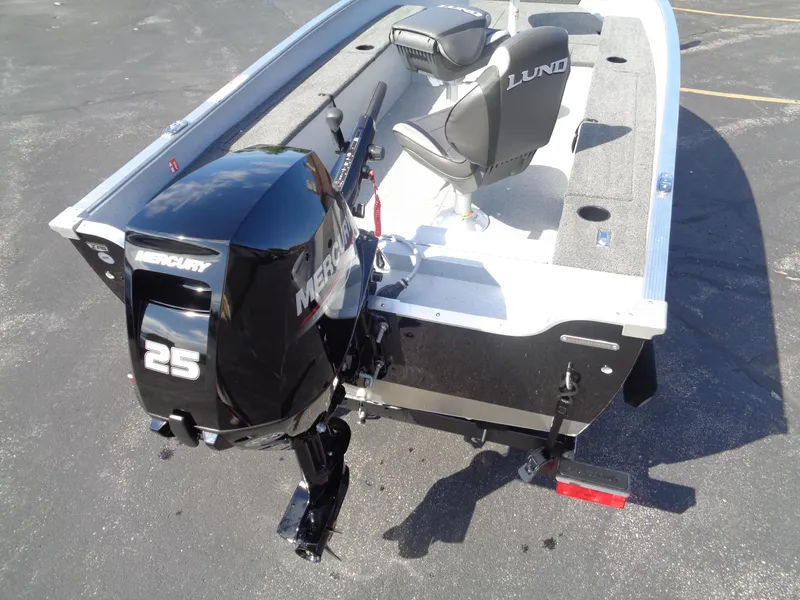 Slide: The Image of 2025 Lund 1400 Fury Tiller boat with Mercury 25 outboard motor, featuring dual seats. - 4