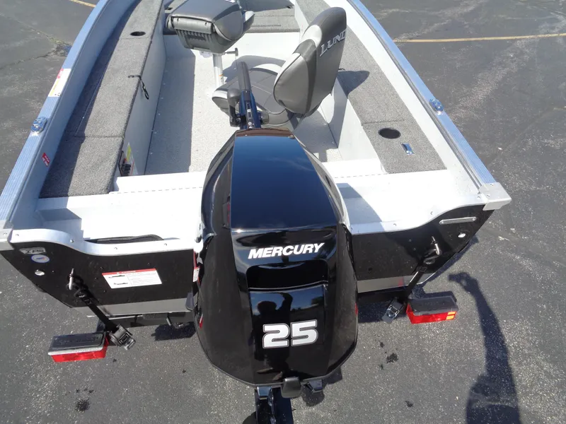 Slide: The Image of 2025 Lund 1400 Fury Tiller boat with Mercury 25 outboard motor, viewed from above. - 5