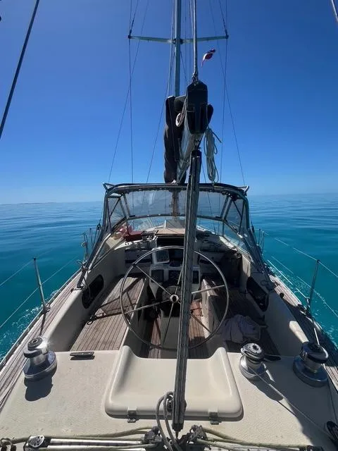 Slide: The Image of Sailing yacht Maxi 35 CC, 1990 model, on calm blue waters under clear skies. - 10
