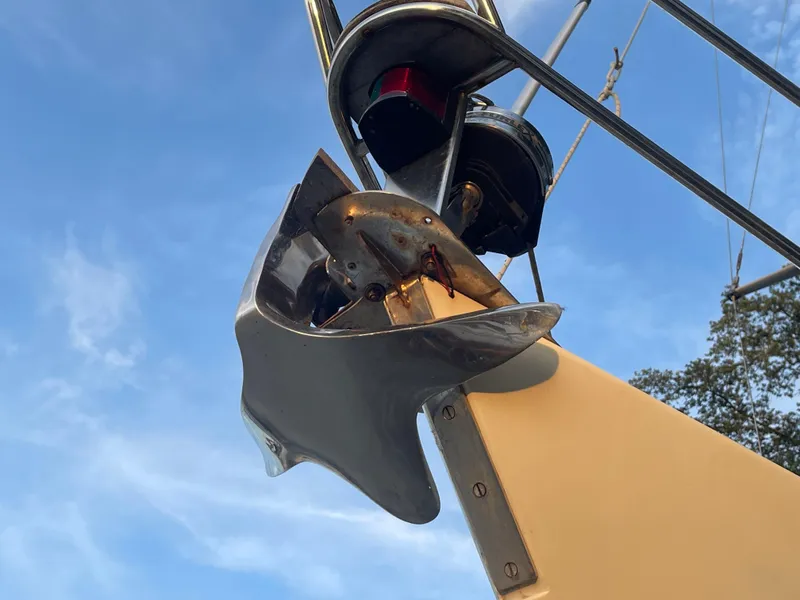 Slide: The Image of Close-up of a 1990 Maxi 35 CC sailboat anchor against a blue sky. - 16