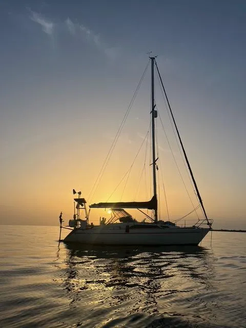 Slide: The Image of Sailboat Maxi 35 CC 1990 at sunset on calm water. - 2