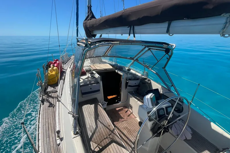 Slide: The Image of Sailing on a 1990 Maxi 35 CC yacht in calm, clear blue waters. - 21