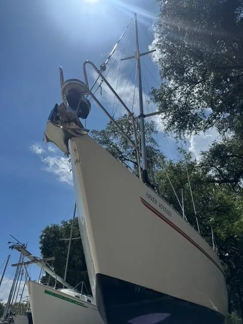 Slide: The Image of Sailboat Maxi 35 CC 1990 under clear sky, surrounded by trees. - 25