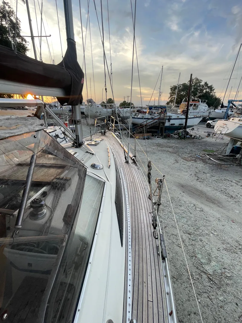 Slide: The Image of Sailboat Maxi 35 CC, 1990 model, docked at sunset with other boats nearby. - 26