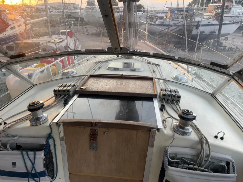 Slide: The Image of Cockpit view of 1990 Maxi 35 CC sailboat with winches and ropes, docked at sunset. - 32