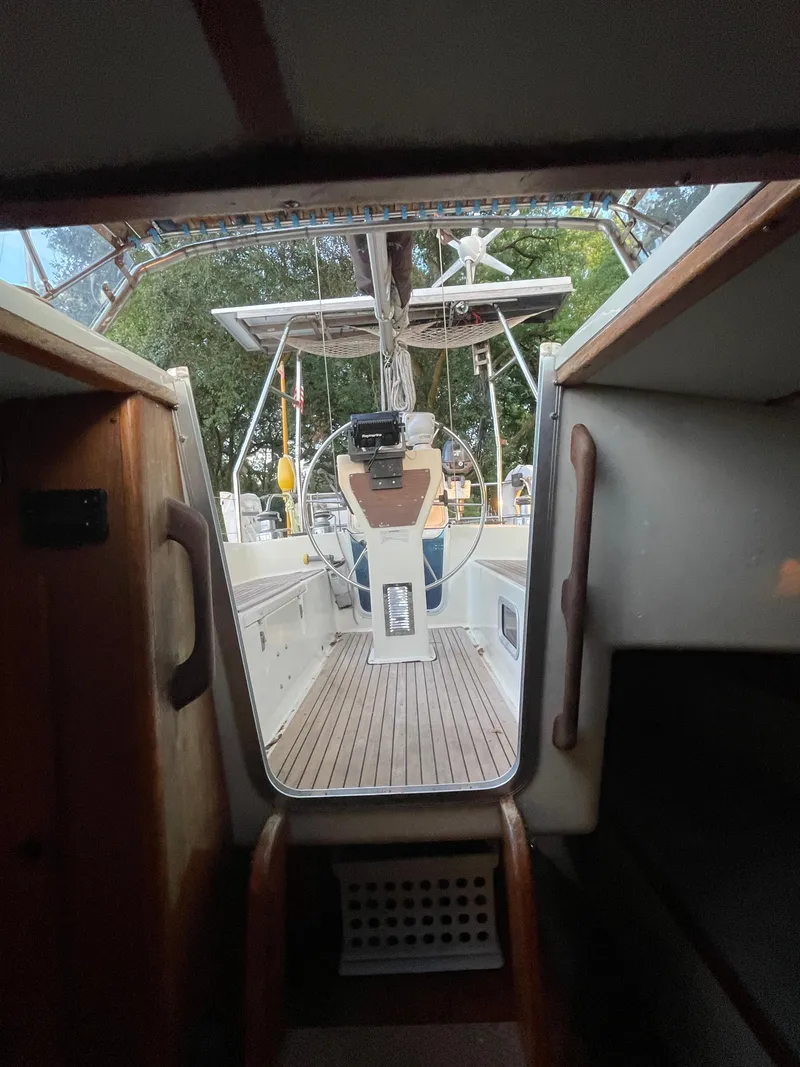Slide: The Image of Interior view of 1990 Maxi 35 CC sailboat cockpit with wooden flooring. - 33