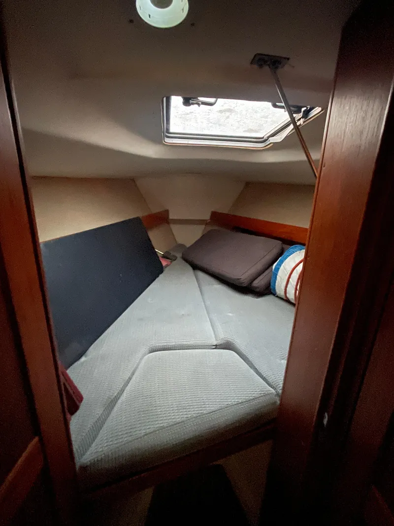 Slide: The Image of Cozy cabin interior of 1990 Maxi 35 CC sailboat with cushions and a skylight. - 36