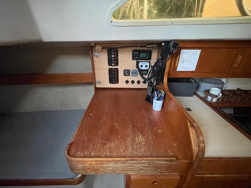 Slide: The Image of Interior of a 1990 Maxi 35 CC sailboat with navigation equipment and wooden desk. - 37