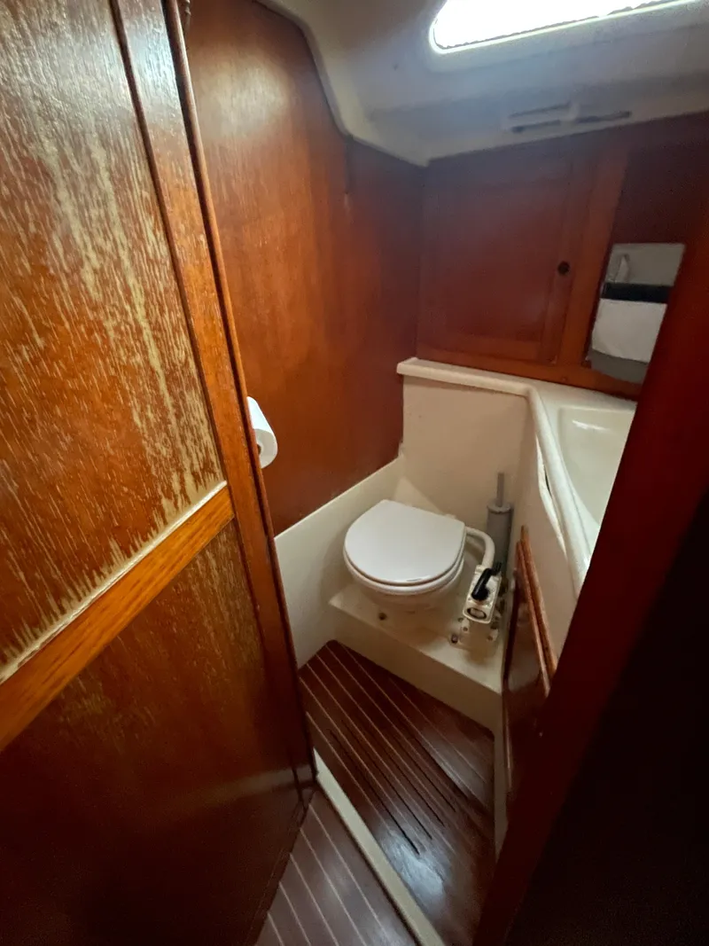 Slide: The Image of 1990 Maxi 35 CC yacht bathroom with wooden interior and compact design. - 38