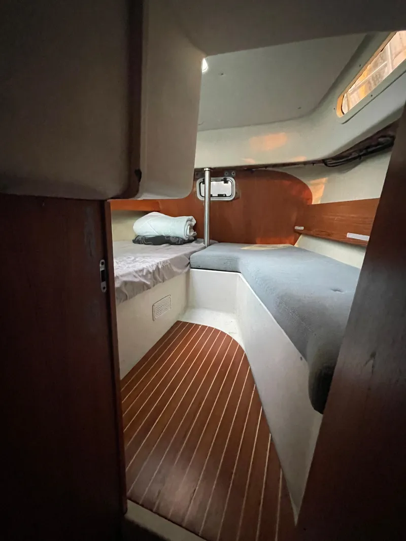 Slide: The Image of Interior cabin of 1990 Maxi 35 CC sailboat with wooden flooring and cozy sleeping area. - 39