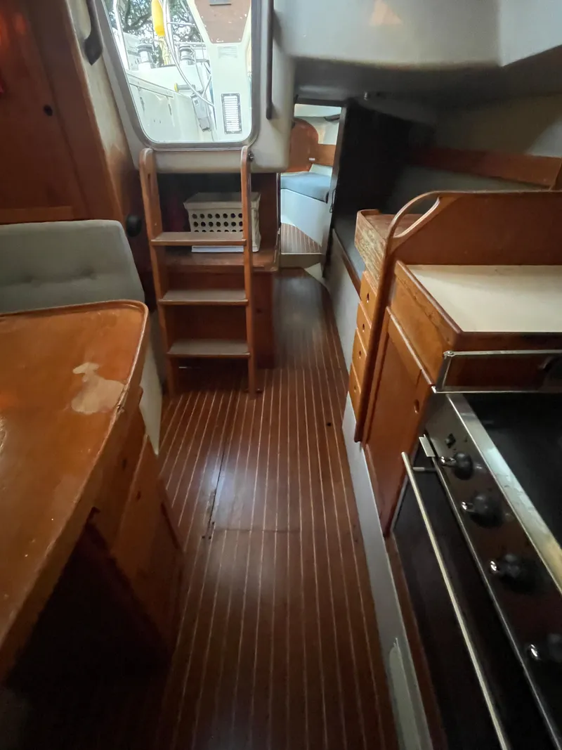 Slide: The Image of Interior of 1990 Maxi 35 CC sailboat with wooden cabinetry and compact kitchen. - 41