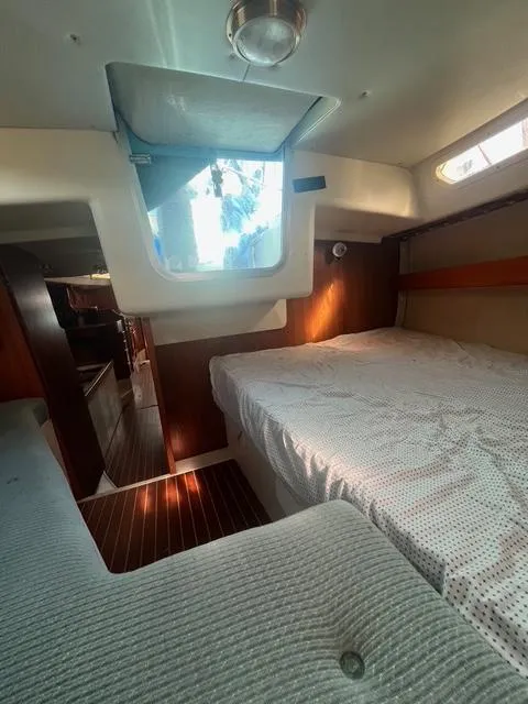 Slide: The Image of Cozy cabin interior of 1990 Maxi 35 CC sailboat with bed and window. - 45
