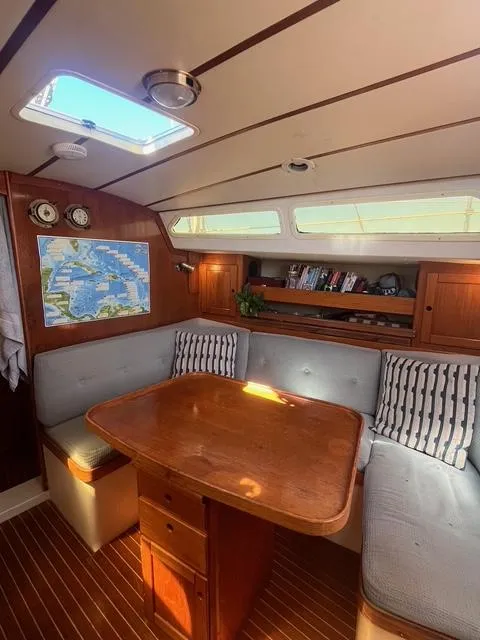 Slide: The Image of Cozy interior of 1990 Maxi 35 CC sailboat with wooden table and seating area. - 47