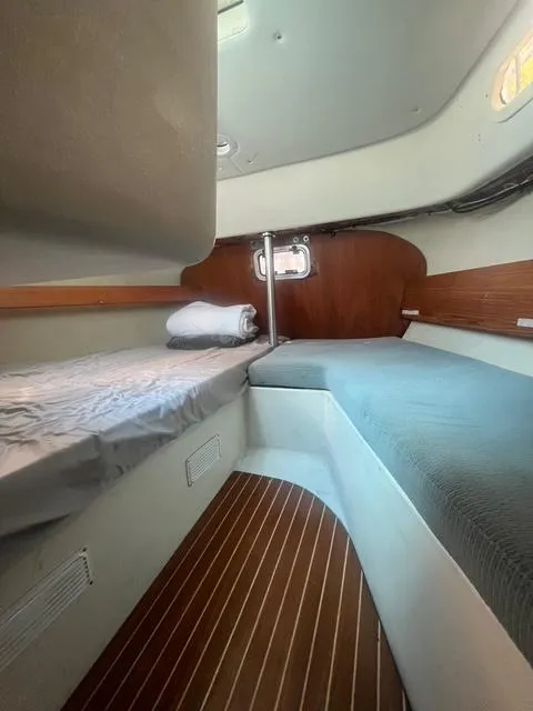 Slide: The Image of Interior of 1990 Maxi 35 CC sailboat with cozy sleeping area and wooden accents. - 49