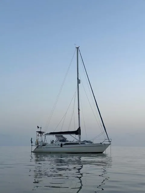 Slide: The Image of Sailboat Maxi 35 CC 1990 on calm water at sunset. - 5
