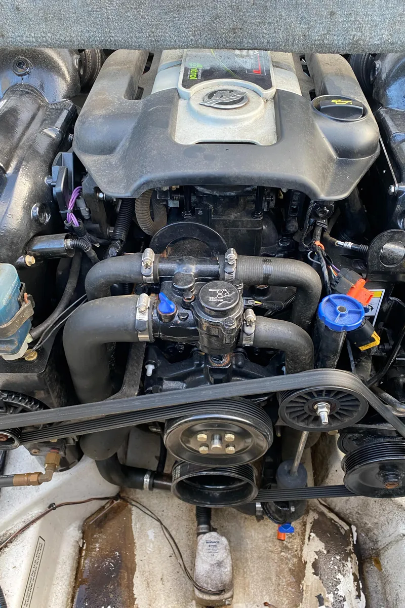 Slide: The Image of Engine of a 2013 Sea Ray 205 Sport boat, showcasing detailed components and layout. - 10