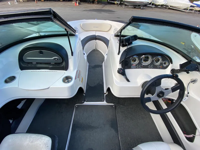 Slide: The Image of 2013 Sea Ray 205 Sport boat interior with steering wheel and dashboard controls. - 5