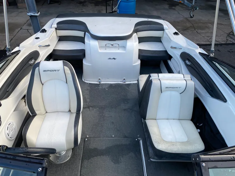 Slide: The Image of 2013 Sea Ray 205 Sport boat interior with white and gray seating. - 8