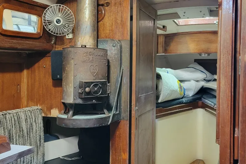Slide: The Image of Interior of 1968 Cheoy Lee Herreshoff 31 Ketch with vintage stove and rolled sails. - 14
