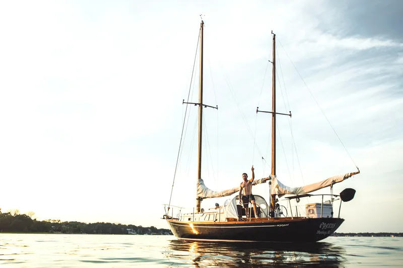 Slide: The Image of 1968 Cheoy Lee Herreshoff 31 Offshore Ketch sailing on calm waters at sunset. - 2