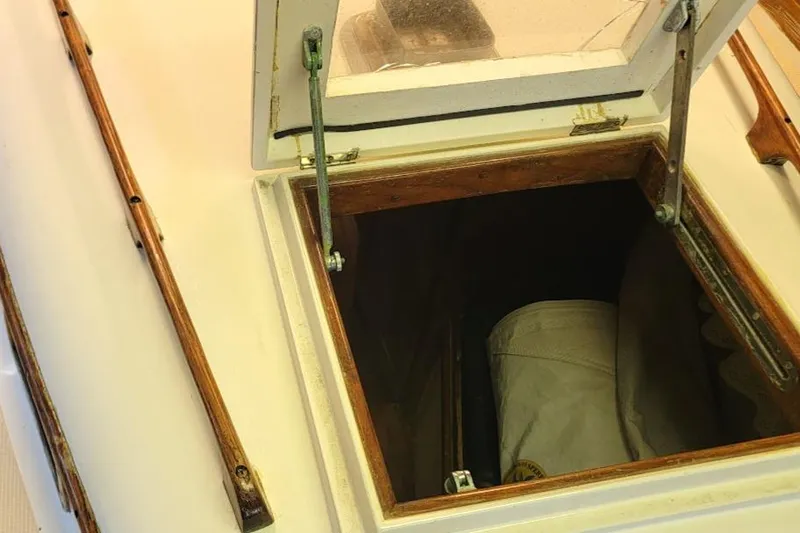 Slide: The Image of Open hatch on 1968 Cheoy Lee Herreshoff 31 Offshore Ketch, revealing interior storage. - 27