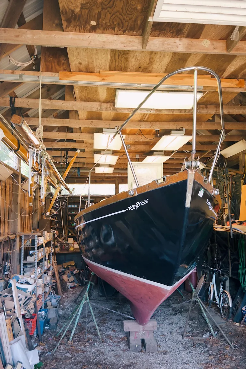 Slide: The Image of 1968 Cheoy Lee Herreshoff 31 Offshore Ketch in a workshop, undergoing maintenance. - 3