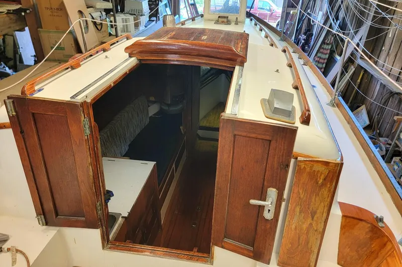 Slide: The Image of 1968 Cheoy Lee Herreshoff 31 Offshore Ketch interior with wooden cabin entrance. - 34