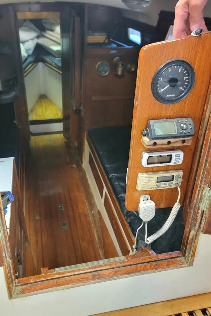 Slide: The Image of Interior of 1968 Cheoy Lee Herreshoff 31 Offshore Ketch, featuring navigation instruments and cozy cabin. - 35