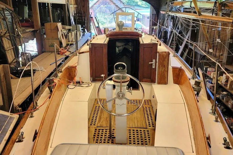Slide: The Image of 1968 Cheoy Lee Herreshoff 31 Offshore Ketch interior with wooden details and steering wheel. - 41
