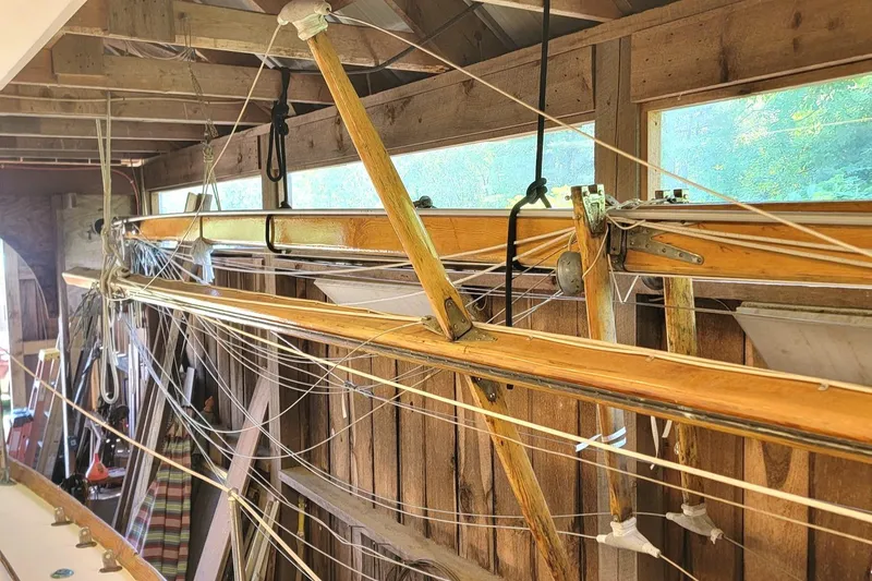 Slide: The Image of 1968 Cheoy Lee Herreshoff 31 Offshore Ketch mast and rigging in a wooden shed. - 42