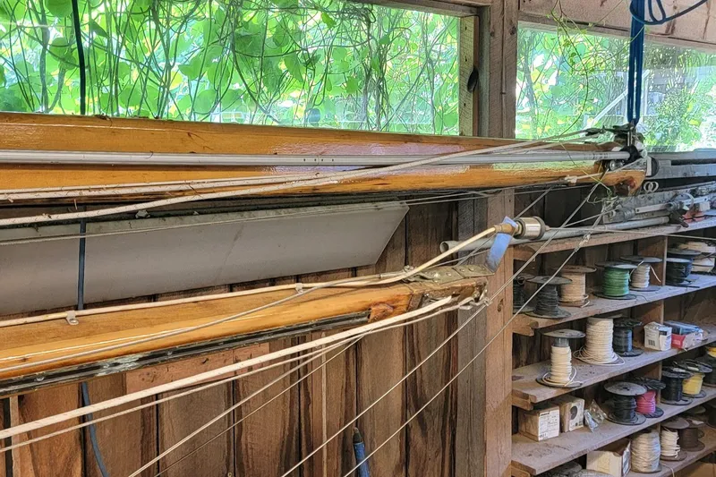 Slide: The Image of Wooden mast and rigging of a 1968 Cheoy Lee Herreshoff 31 Offshore Ketch in a workshop. - 43