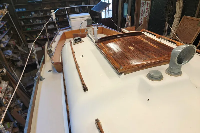 Slide: The Image of 1968 Cheoy Lee Herreshoff 31 Offshore Ketch deck with wooden details in a workshop setting. - 44