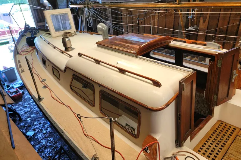 Slide: The Image of 1968 Cheoy Lee Herreshoff 31 Offshore Ketch with wooden accents and open cabin doors. - 46