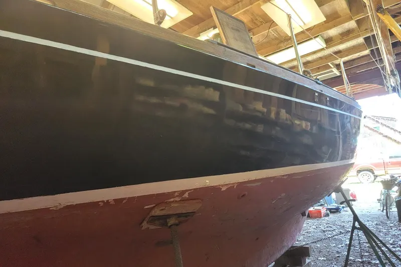 Slide: The Image of 1968 Cheoy Lee Herreshoff 31 Offshore Ketch in a workshop, showing hull details. - 49