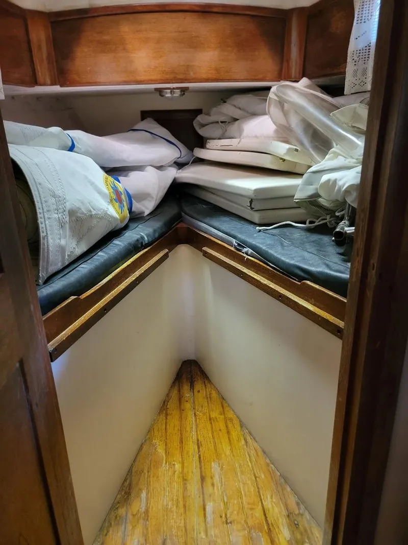 Slide: The Image of 1968 Cheoy Lee Herreshoff 31 Offshore Ketch interior with wooden flooring and storage. - 7