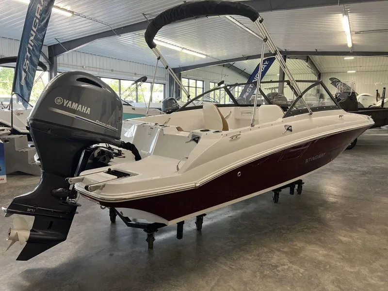 Slide: The Image of 2026 Stingray 191 DC boat with Yamaha outboard motor in showroom. - 5