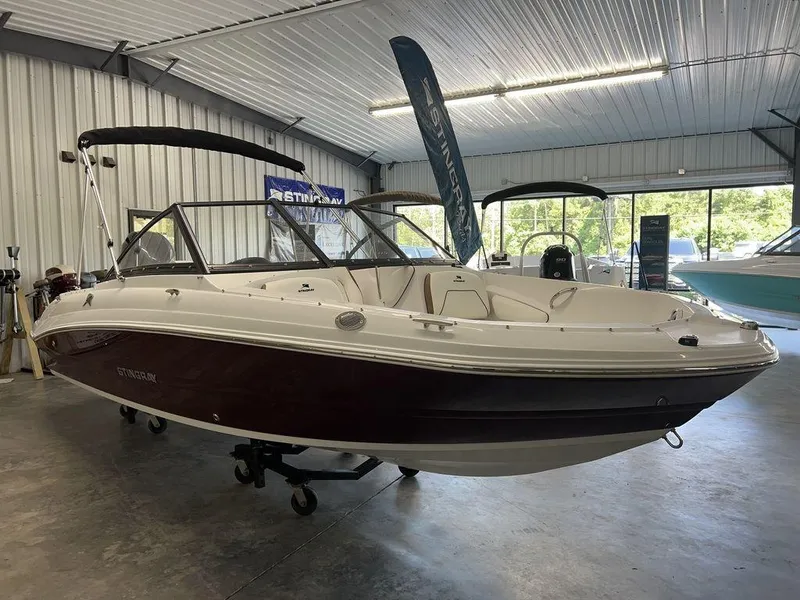 Slide: The Image of 2026 Stingray 191 DC boat cockpit with steering wheel, controls, and navigation equipment. - 7