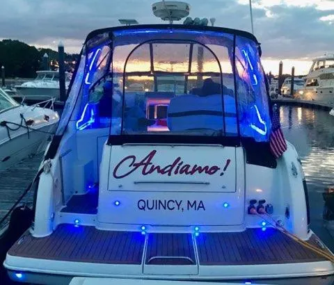 Slide: The Image of 2007 Formula 31 Cruiser boat named "Andiamo" docked in Quincy, MA, with blue lights. - 10