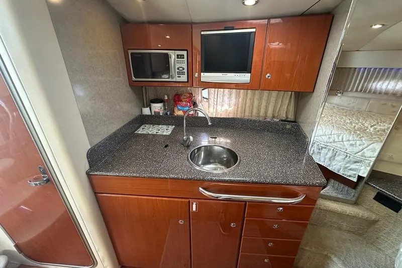 Slide: The Image of 2007 Formula 31 Performance Cruiser kitchen with sink, microwave, and TV. - 14