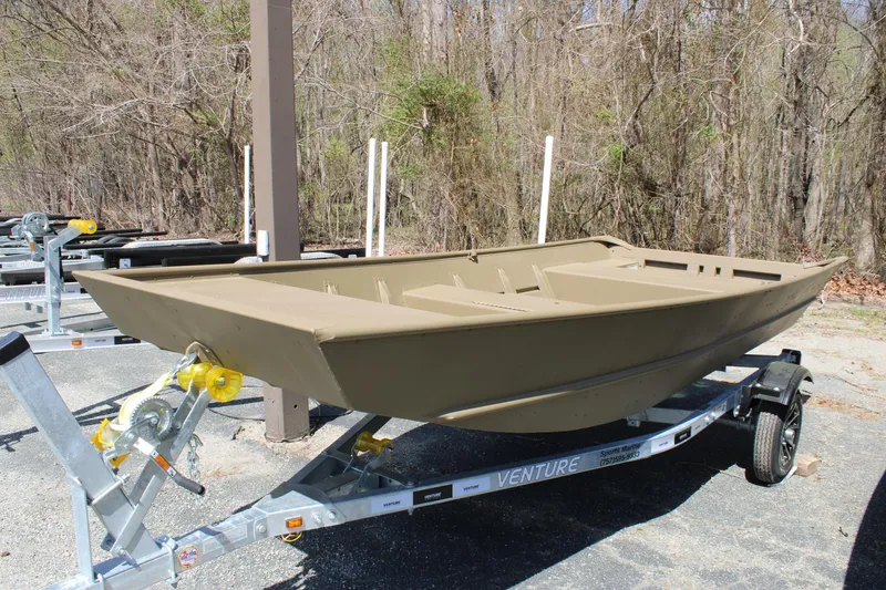 The Image of 2025 G3 Gator Tough 1448 LW boat on trailer, parked outdoors. - 0