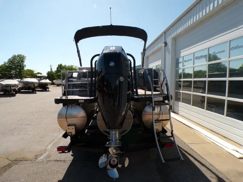 Slide: The Image of 2025 Godfrey AquaPatio 255 SFL iMPACT pontoon boat, rear view with outboard motor. - 18
