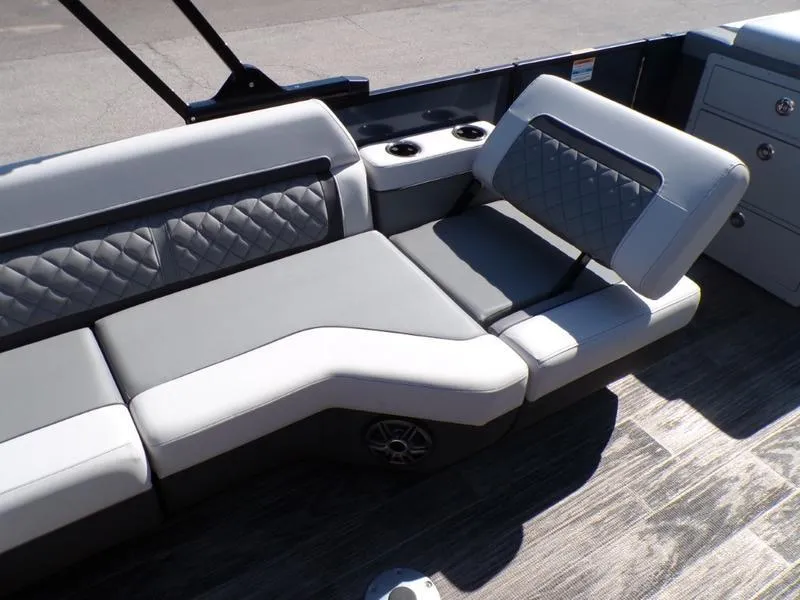 Slide: The Image of 2025 Godfrey AquaPatio 255 SFL boat interior with gray seating and cup holders. - 4