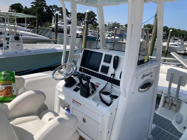 Slide: The Image of 2014 Sea Hunt Gamefish 27 boat console with navigation equipment at marina. - 13