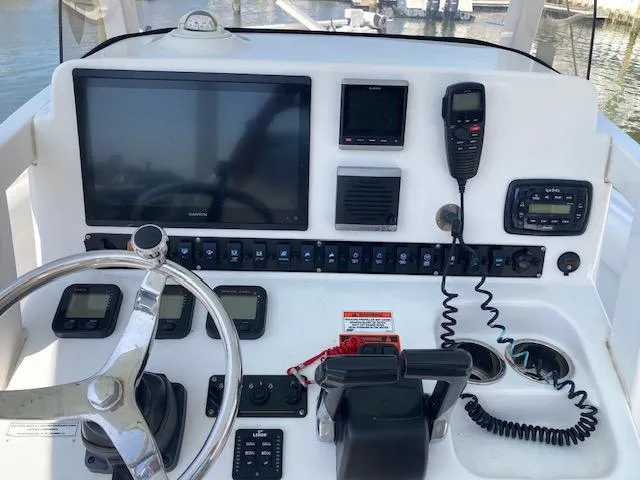 Slide: The Image of 2014 Sea Hunt Gamefish 27 dashboard with navigation and communication equipment. - 15