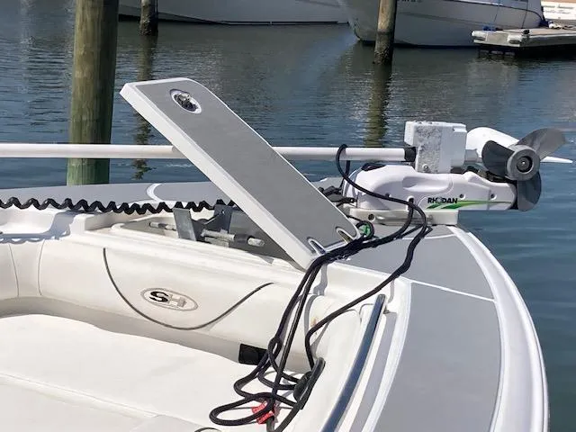 Slide: The Image of 2014 Sea Hunt Gamefish 27 boat with trolling motor and open hatch, docked in marina. - 16
